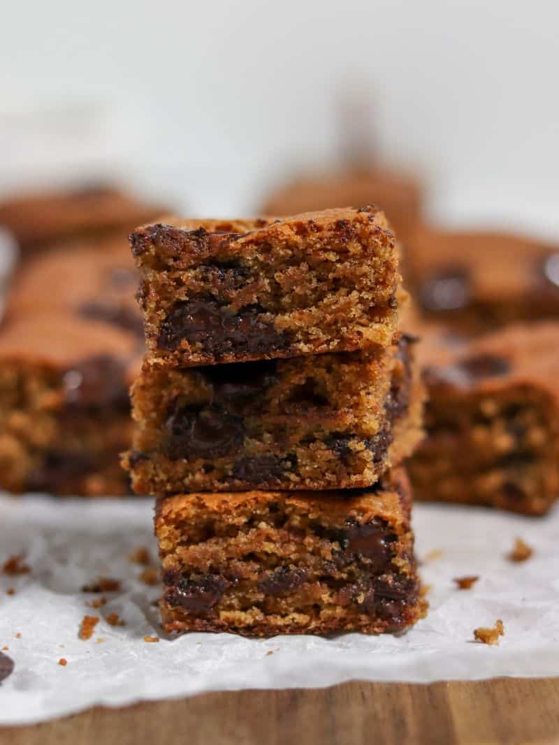 A stack of three soft, fluffy peanut butter chocolate chip blondies