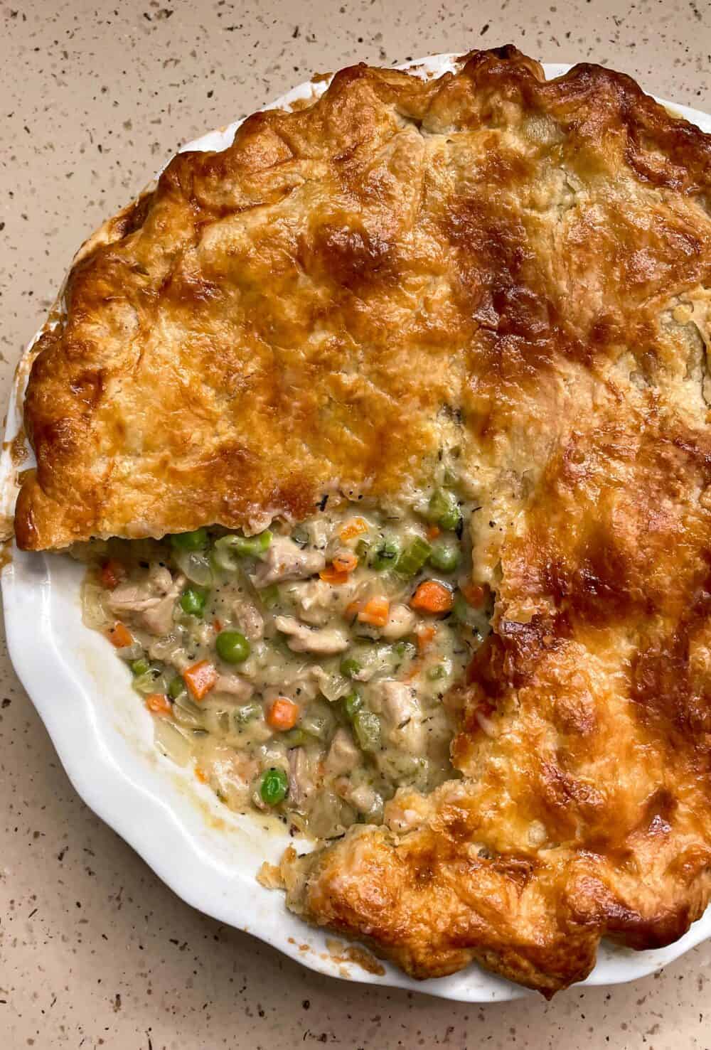 A chicken pot pie with a slice taken out