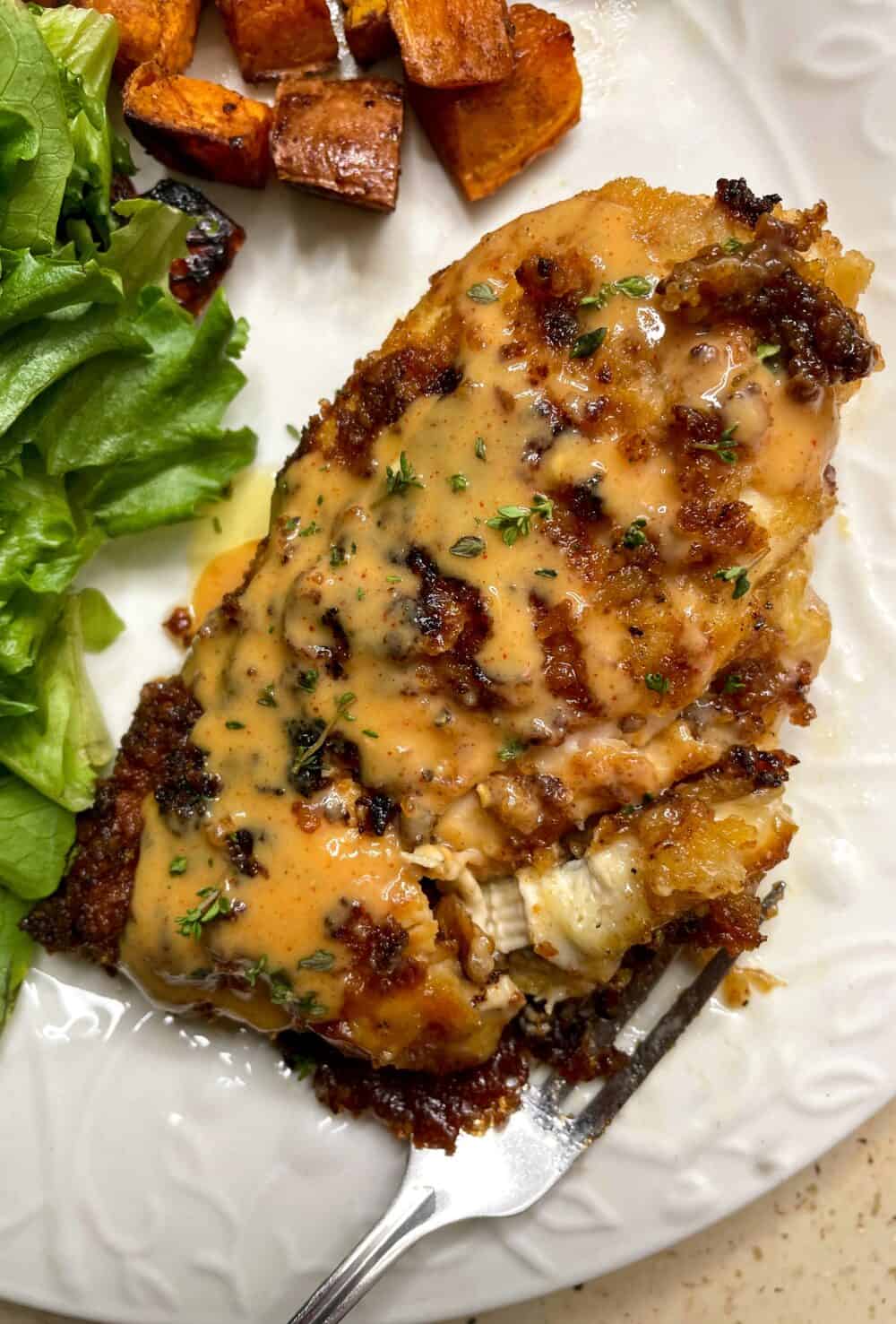 A pretzel-crusted chicken breast stuffed with brie cheese and drizzled with sweet and tangy honey mustard sauce.